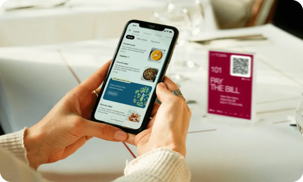 Guest using mobile digital menu ordering app with QR code restaurant payment system for contactless hotel dining