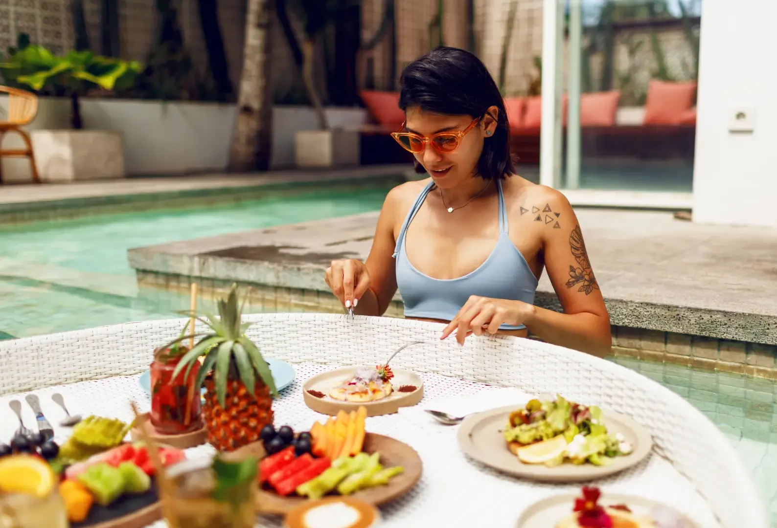 Guest enjoying poolside dining after placing an order through a hotel food ordering app with convenient digital room service