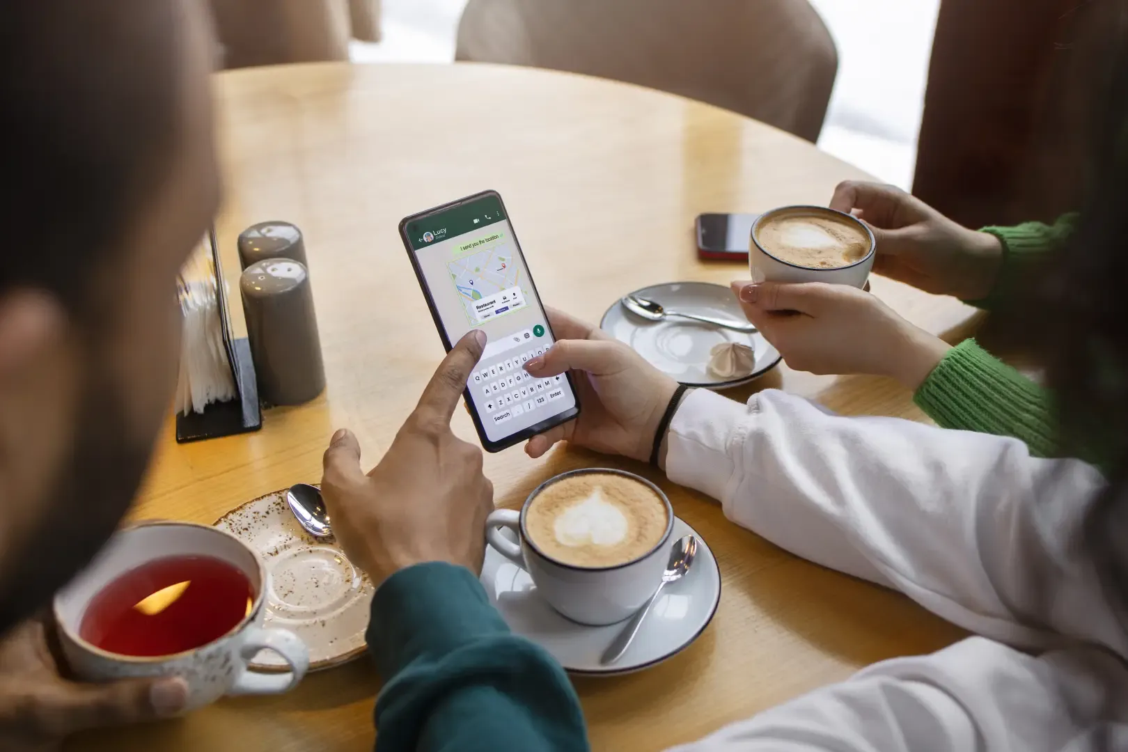 Hotel guests using WhatsApp on a smartphone to browse the menu and place a contactless room service order.