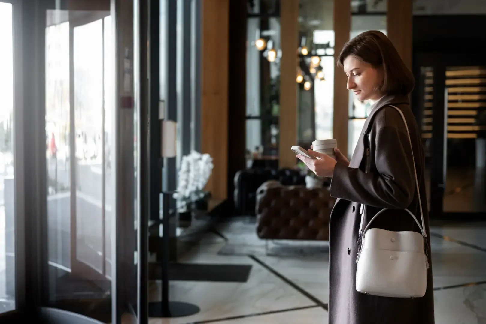 Hotel guest using a smartphone for mobile hotel check-in before accessing room and hotel services